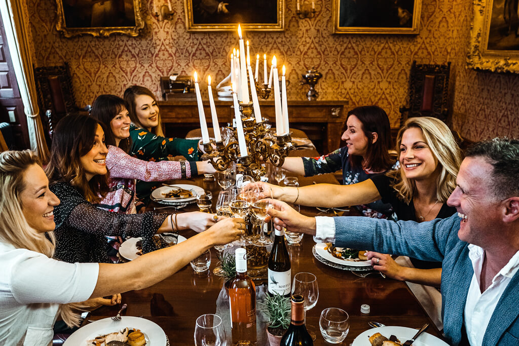Phone of friends sitting at a table given cheers.